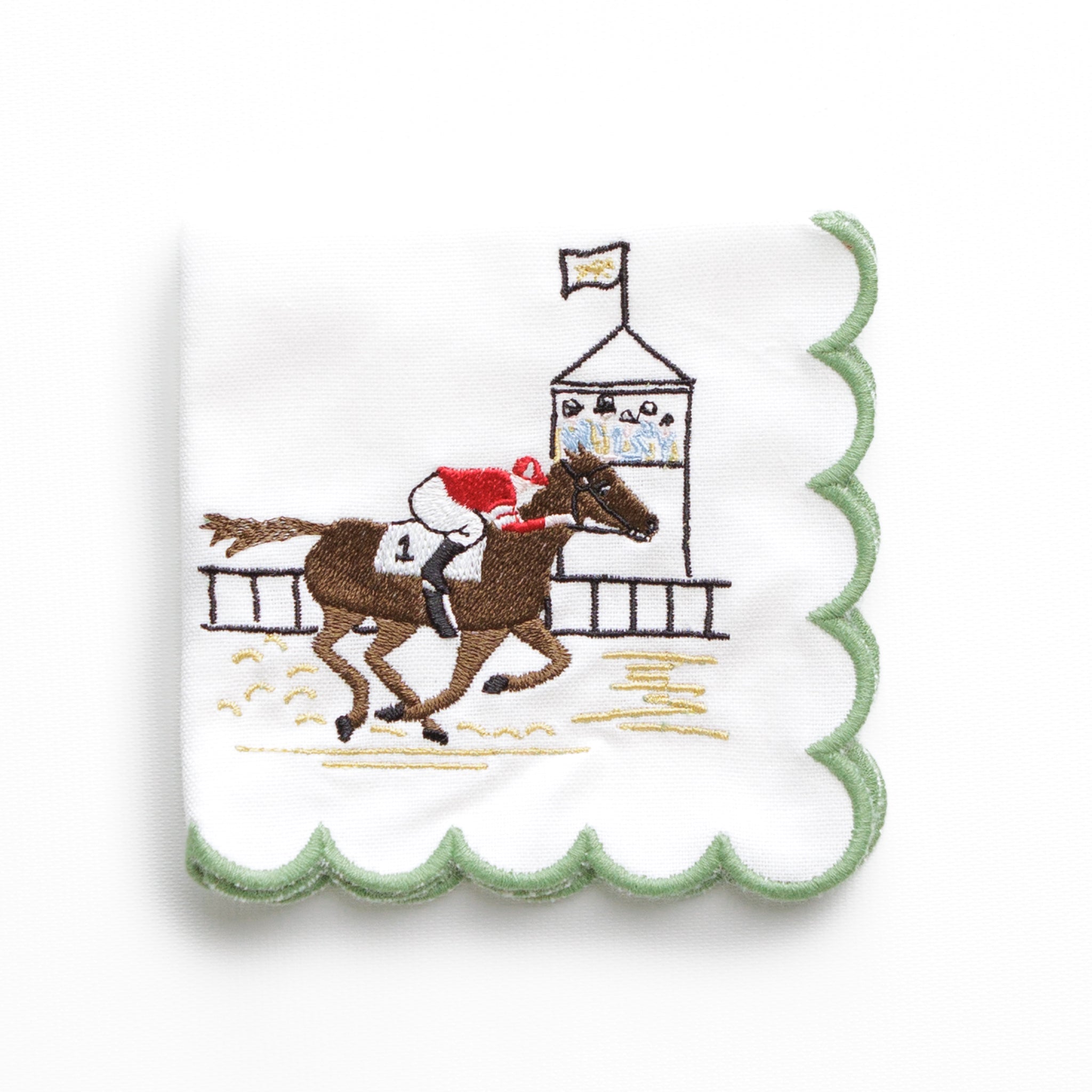 Cocktail napkin with horse racing scene on a white background