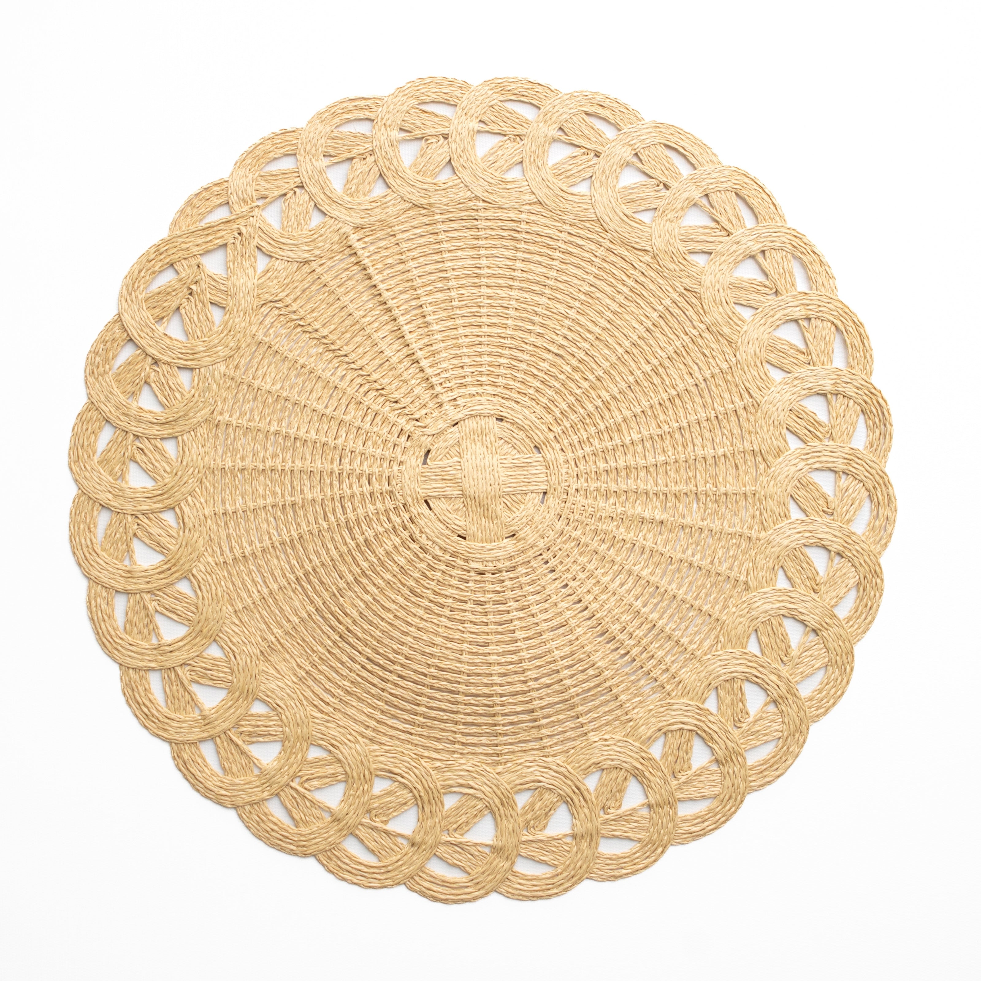 Round woven placemat with intricate design on a white background