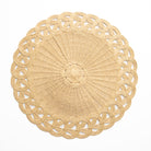 Round woven placemat with intricate design on a white background