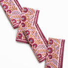 Set of pink floral patterned towels on a white background