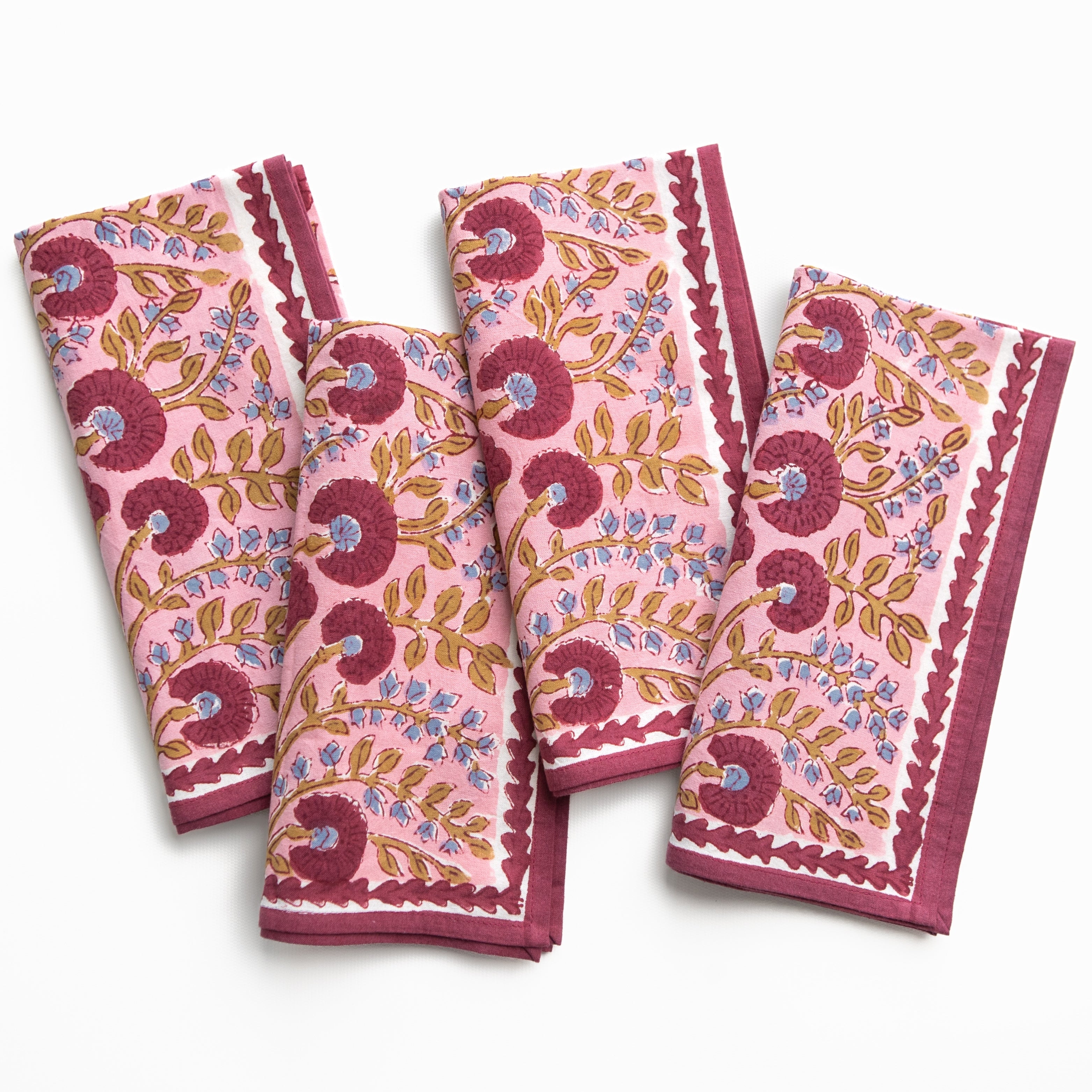 Set of four pink floral patterned towels on a white background