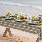 Caroline Green Tablecloth on an outdoor dinner table with wine, flowers, and food.