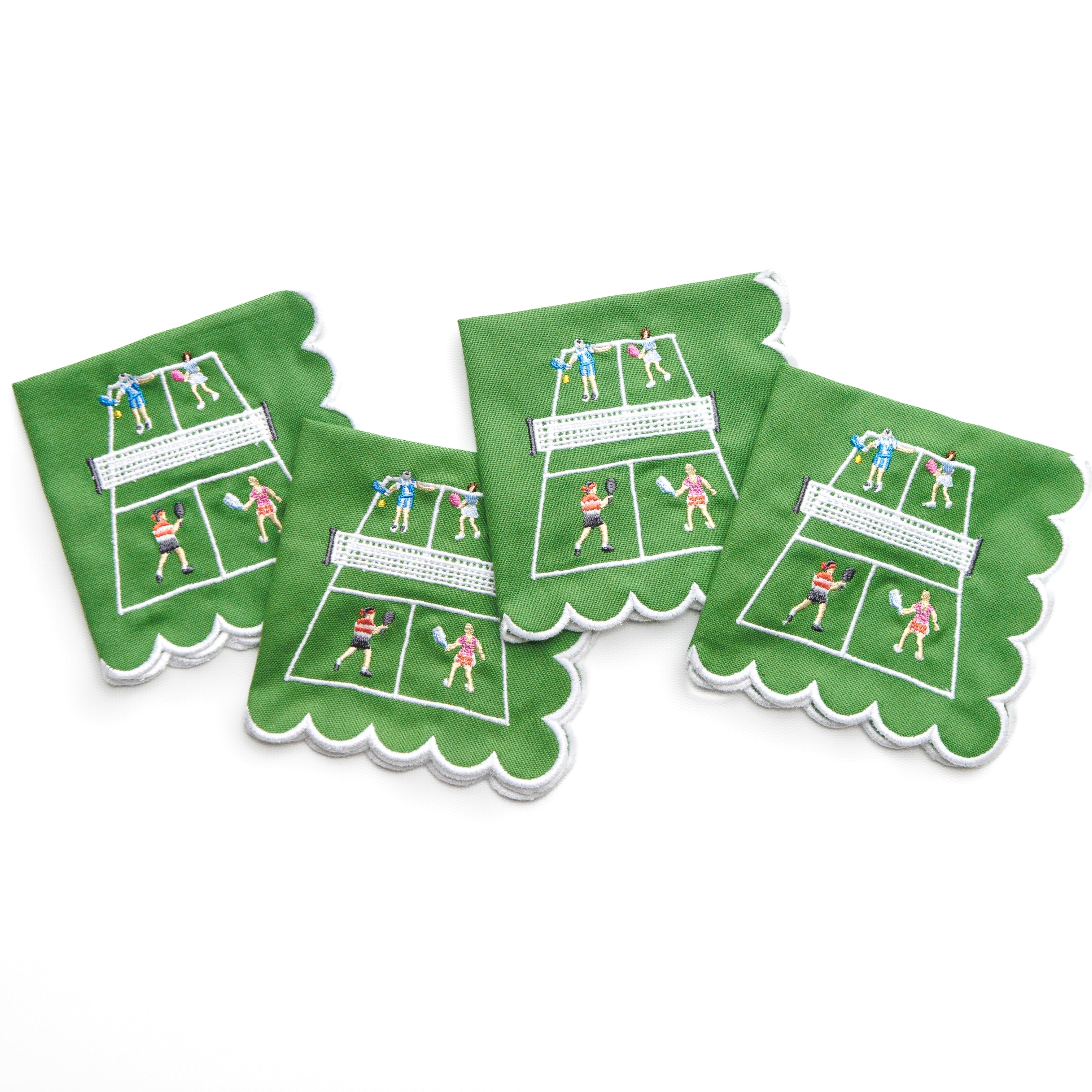 Set of four green cocktail napkins with pickleball designs on a white background