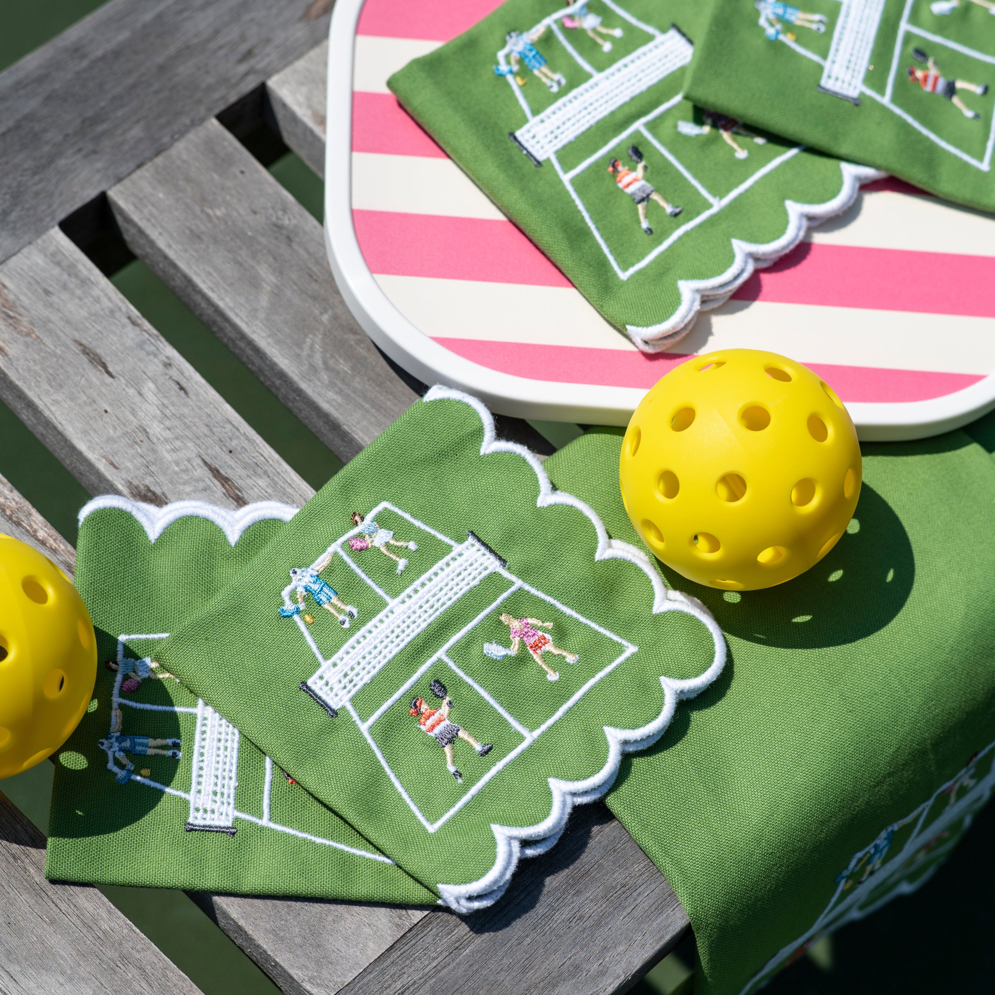 Green cocktail napkins with pickleball designs.
