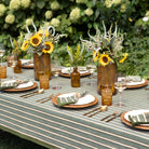 Outdoor table setting with sunflowers and striped tablecloth