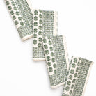 Set of four green and white patterned napkins on a white background