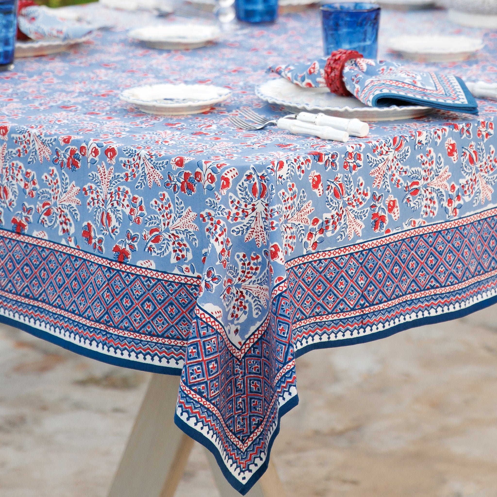 Tablecloth with blue floral pattern on a table set for dinner