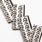 Set of folded napkins with leaf pattern on a white background