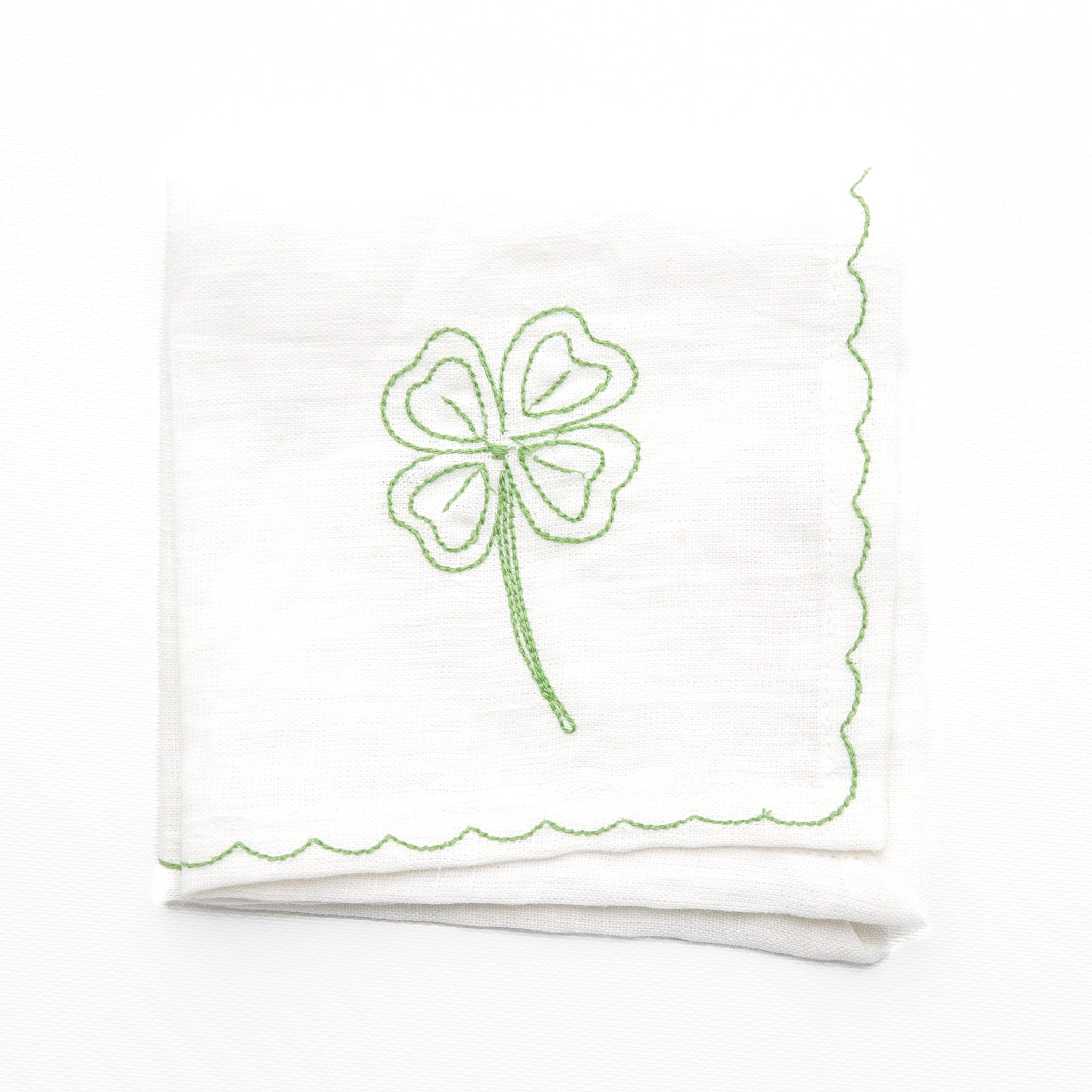 White linen cocktail napkins embroidered with green 4 leaf clover design