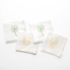 White linen cocktail napkins embroidered with green 4 leaf clover and lucky horse shoe designs