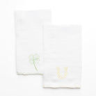 White linen kitchen tea towels embroidered with green 4 leaf clover and lucky horseshoe with scalloped border