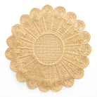 Decorative gold placemat with intricate patterns on a white background