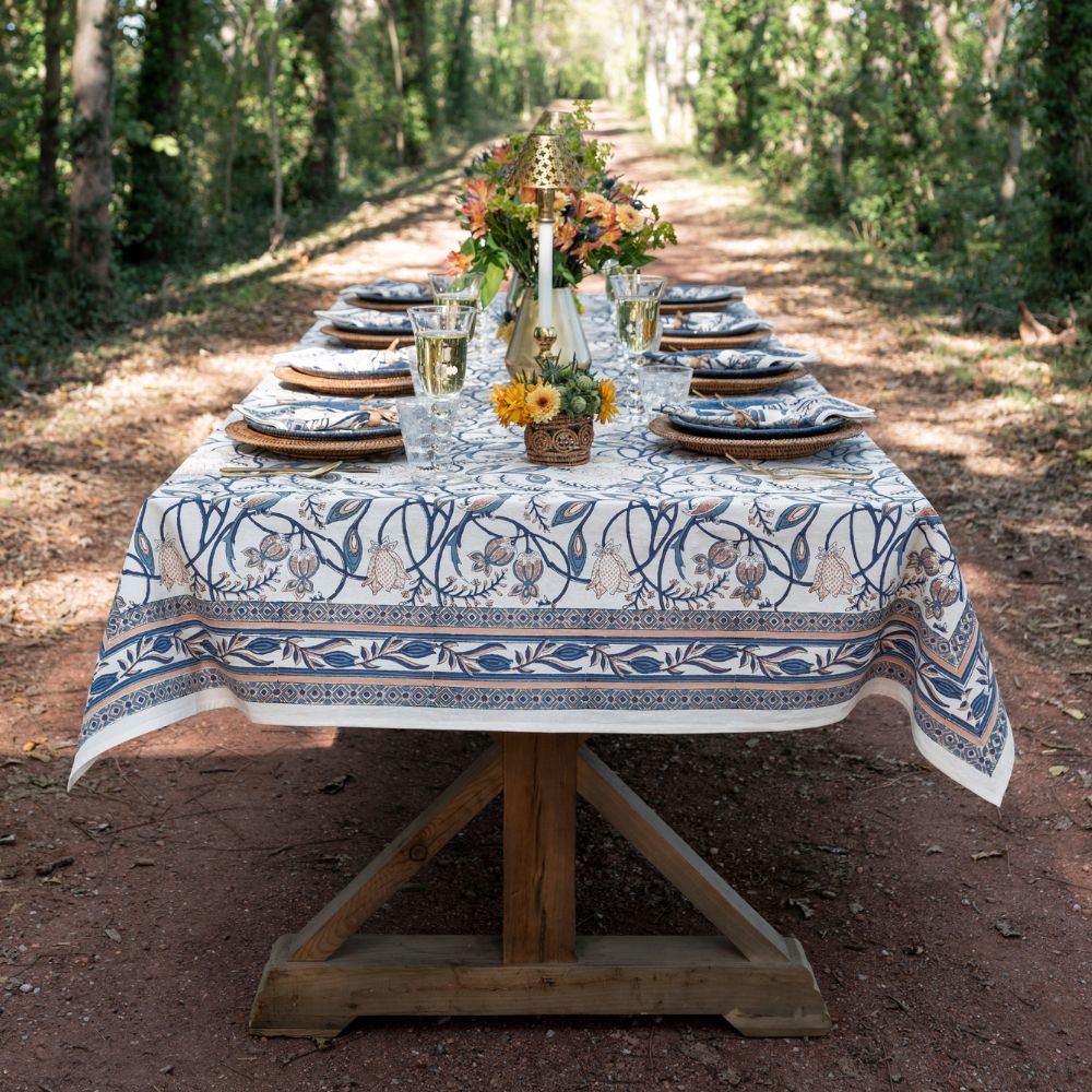 Dining table set with a floral tablecloth in an outdoor setting