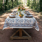 Dining table set with a floral tablecloth in an outdoor setting