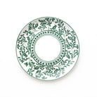 Decorative plate with green leaf pattern on a white background