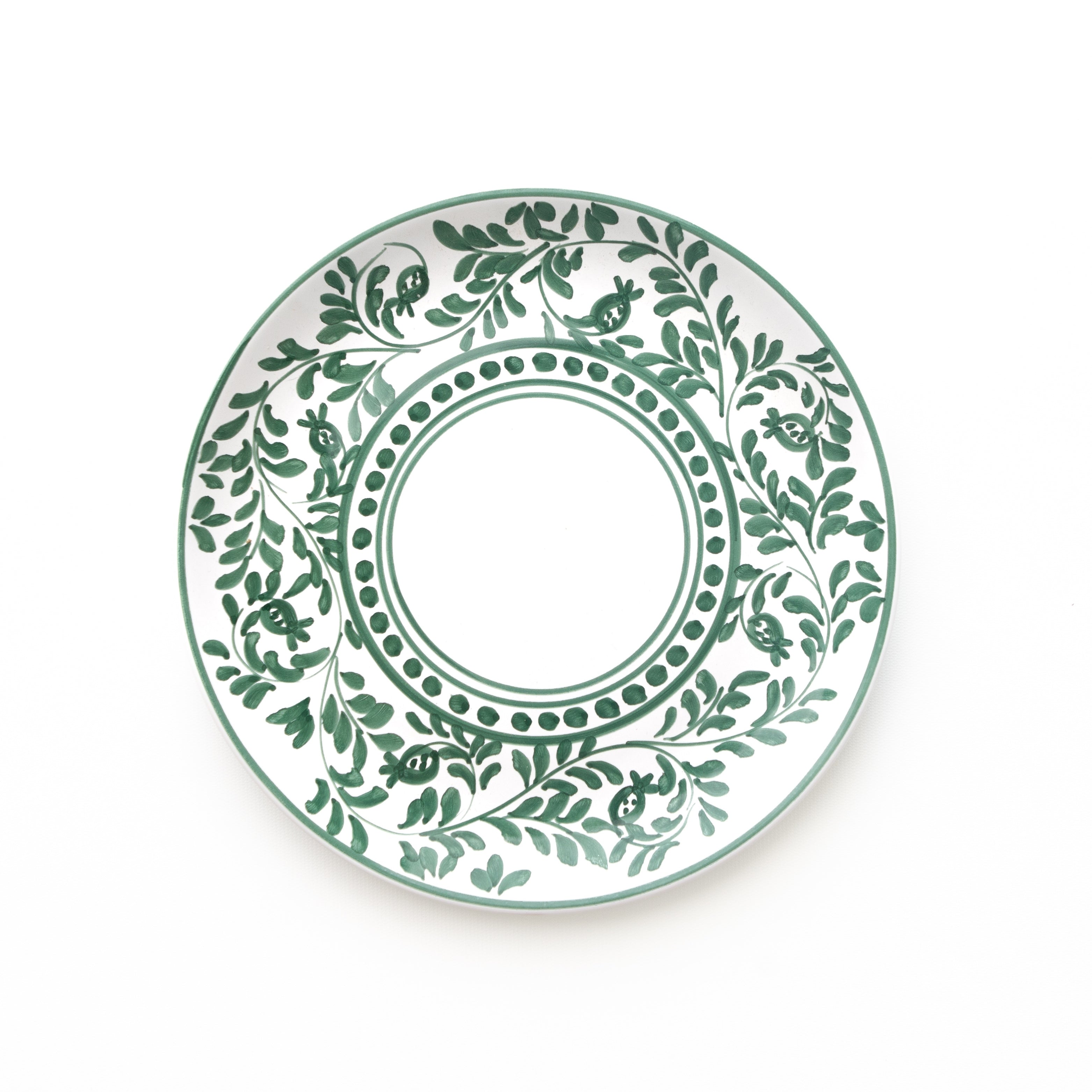 Decorative plate with green leaf pattern on a white background
