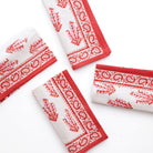 A set of folded Sagar red and white napkins with a hand block-printed design