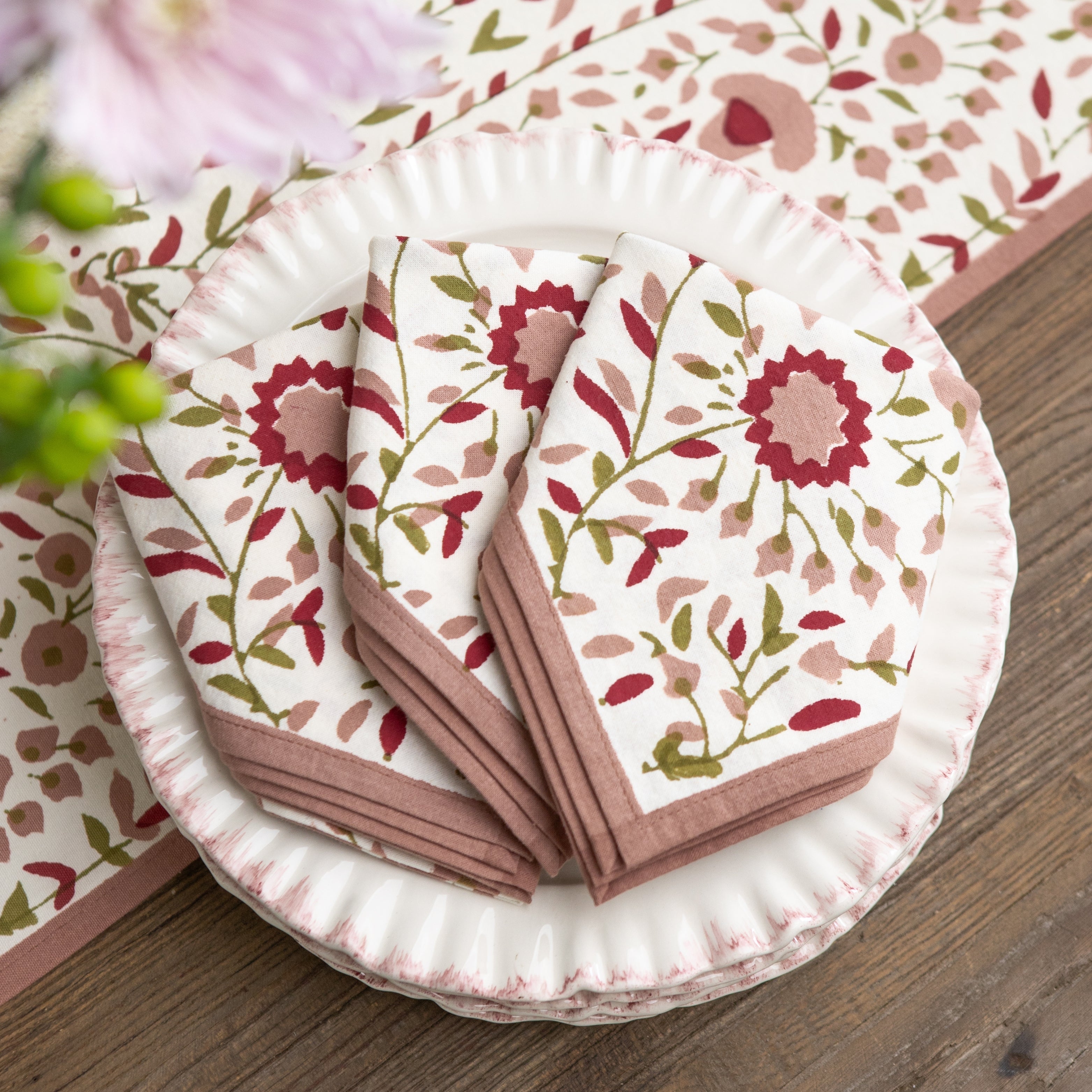 Floral-patterned napkins on a wooden surface