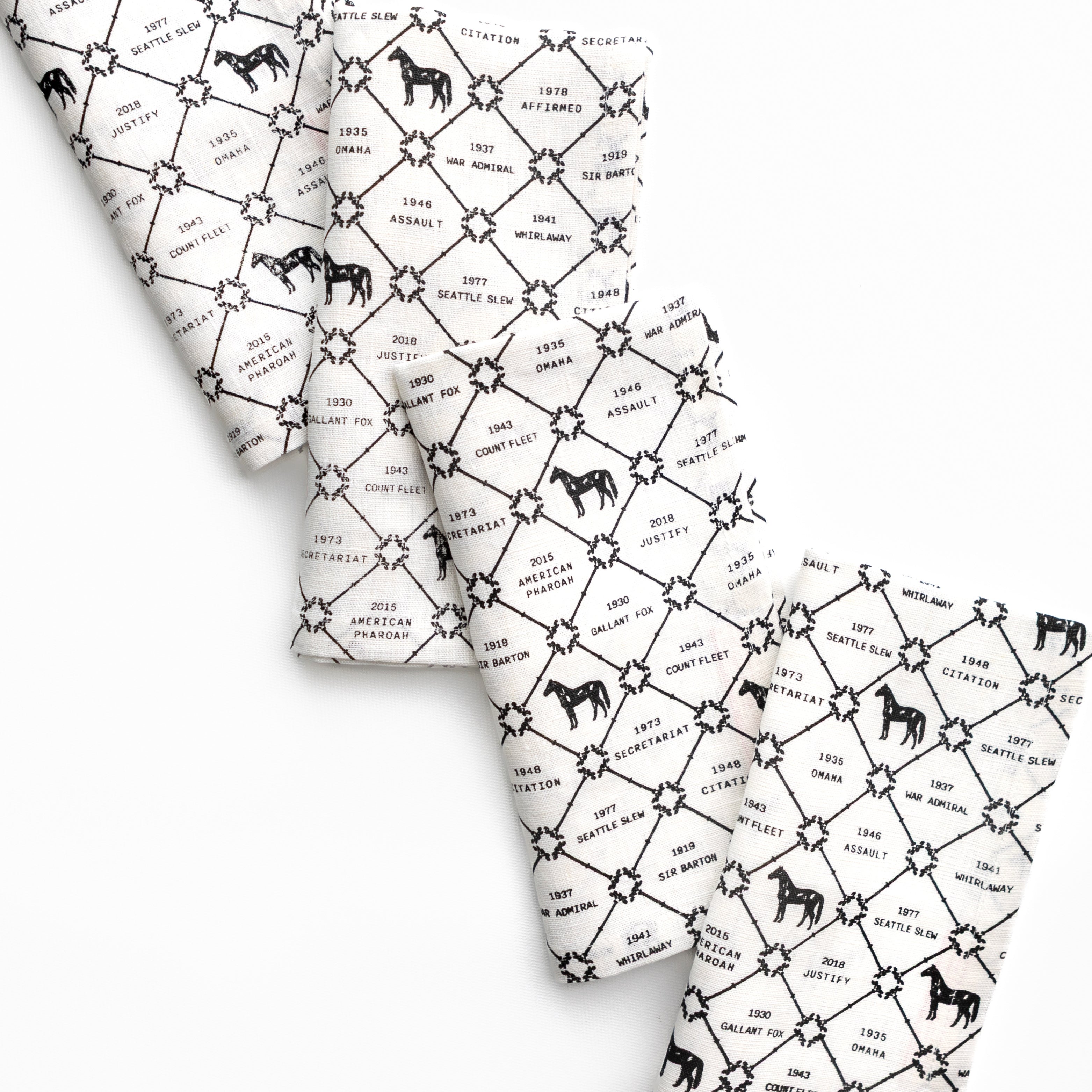 White fabric with black pattern of horses and text on a white background