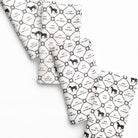 White fabric with black pattern of horses and text on a white background