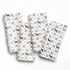 Four white napkins with black horse pattern and text on a white background