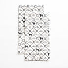 Two folded tea towels with black and white pattern on a white background