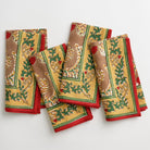 A set of 4 pinecone motif napkins on a white background