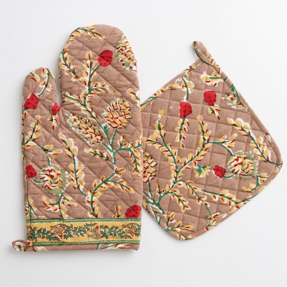 An oven mitt and pot holder with a pinecone motif on a white background