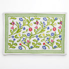 A set of four placemats with a floral pattern in shades of yellow, blue, and red