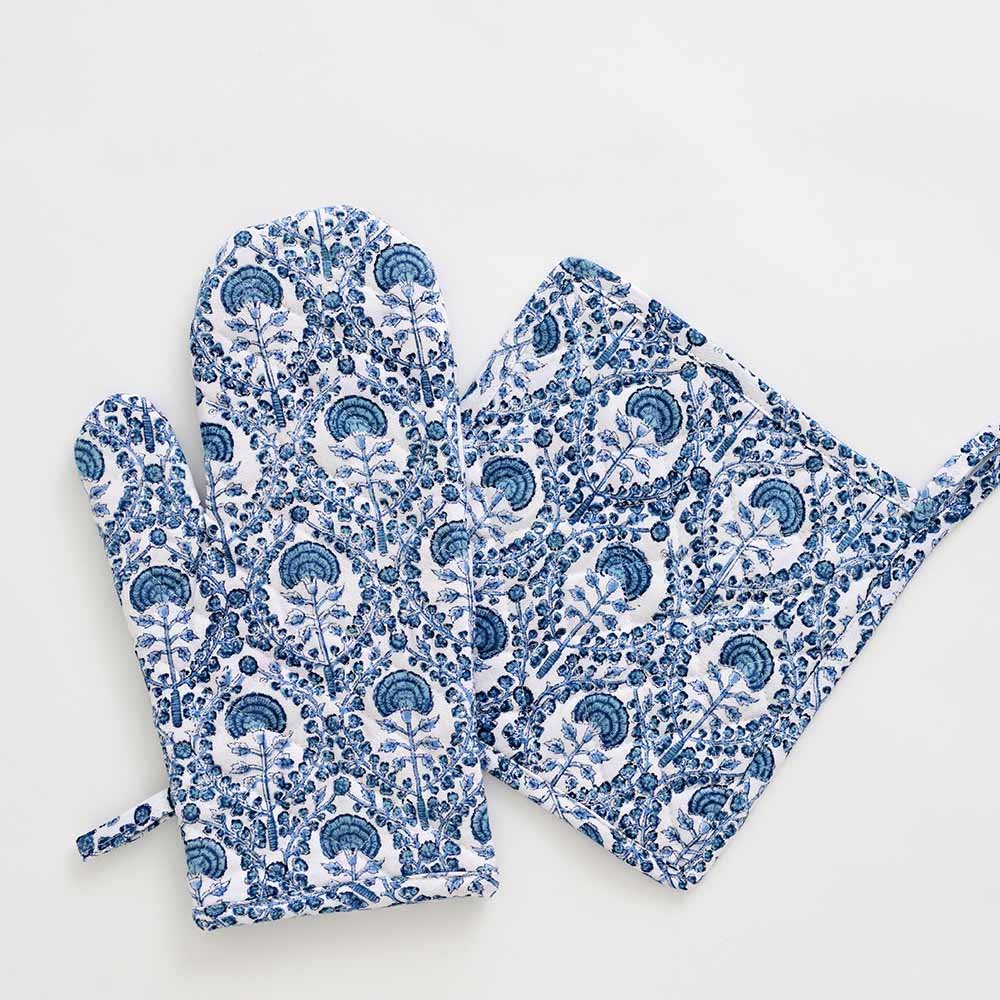 Warm blue hues paired with solid white to give a modern yet global look to this oven mitt set.