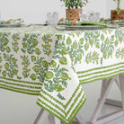 Corner shot of Pom Bells Green tablecloth with leaf border.