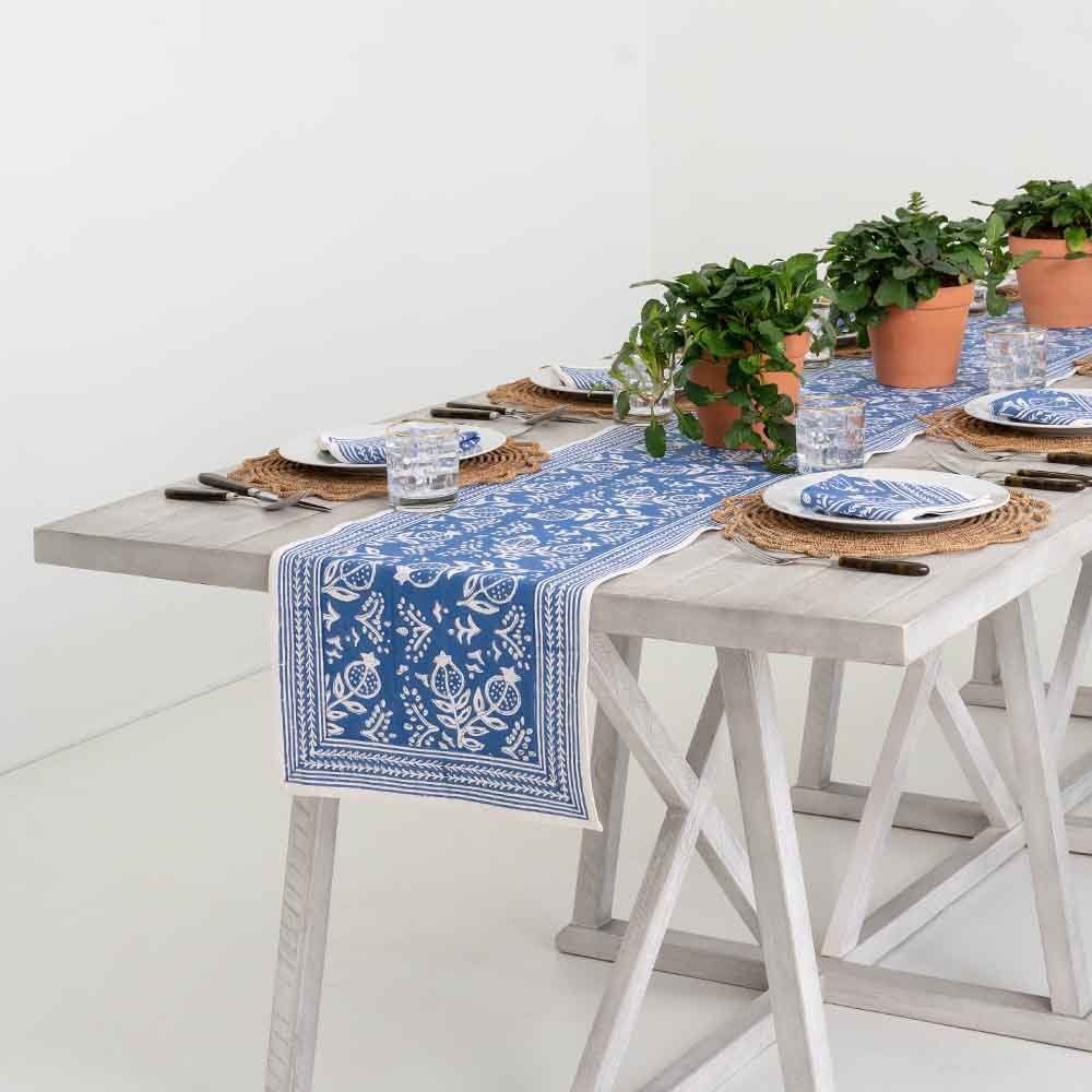Pomegranate Blue table runner with matching napkins and plants.