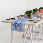 Pomegranate Blue table runner with matching napkins and plants.