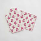 Pink and white oven mitt and pot holder set.