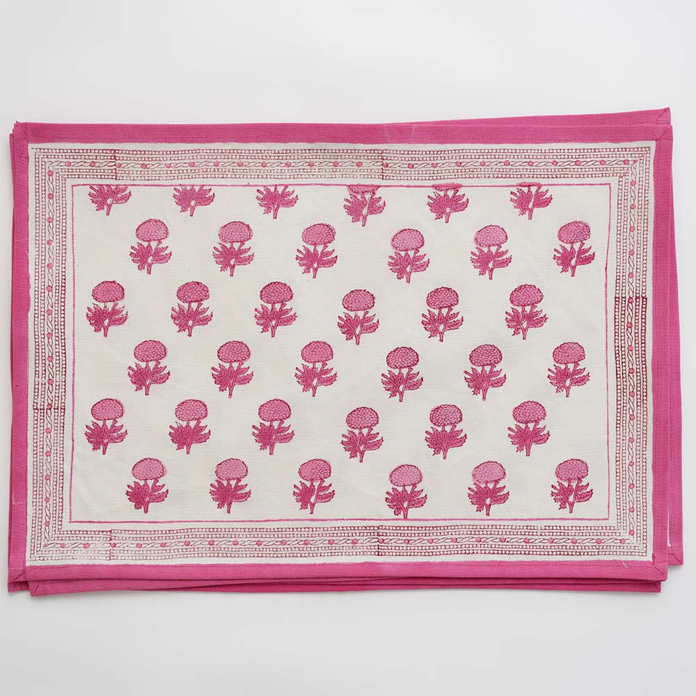Pink and white floral print placemat with pink border outline.