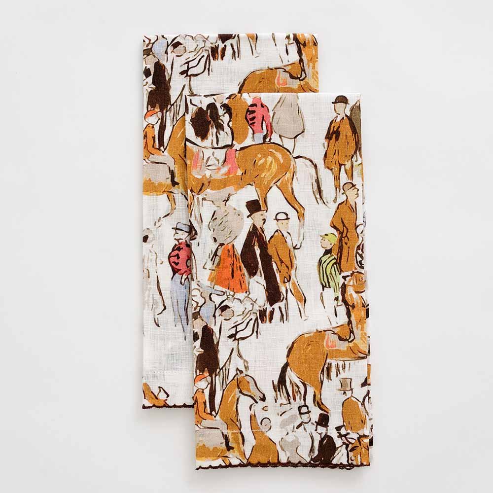 A set of two linen fingertip towels with a hand-sketched paddock scene including horses and people dressed in vintage attire.