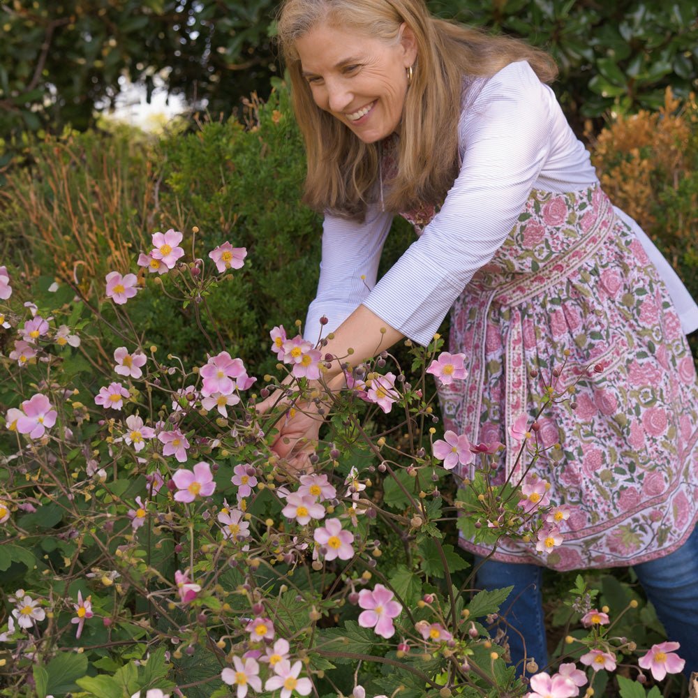Model wearing Bohemian Floral Moss Green & Mauve Pink apron