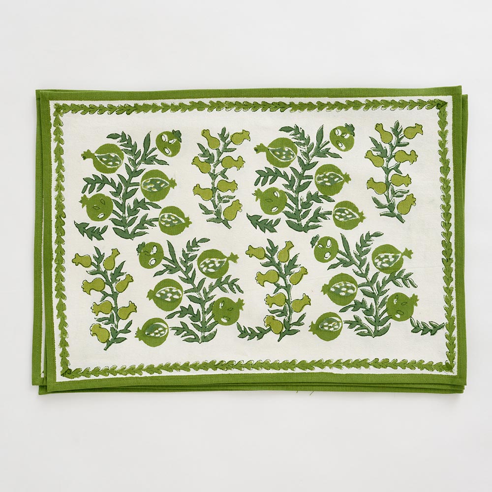 Pom Bells Green Placemat with leaves and pomegranates.