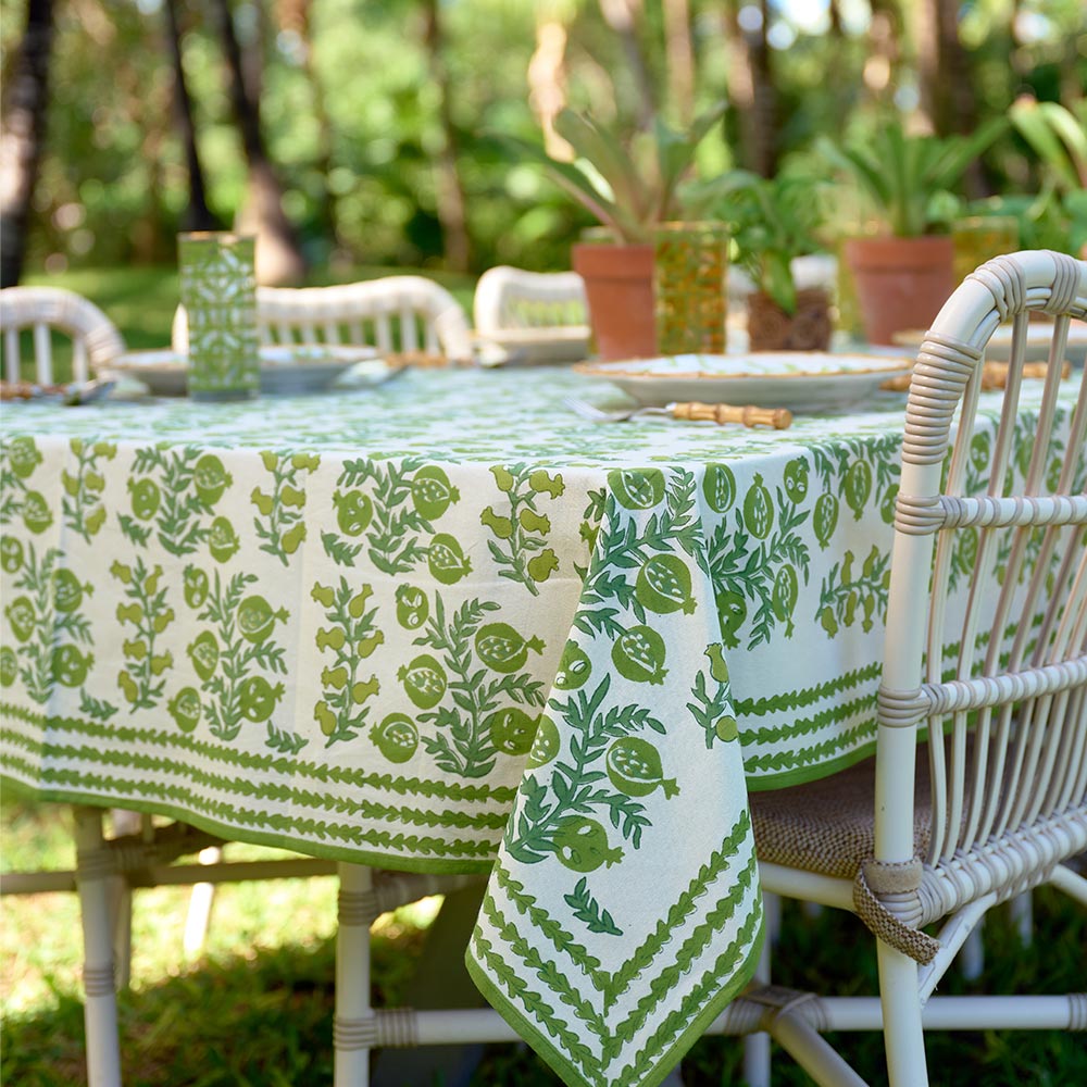 Outdoor table with close up of green and white design.