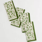 A set of 4 holly berry printed napkins on a white background