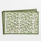 Green and white printed placemats on a white background