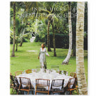 A cover image of a book titled 'An Entertaining Story' by India Hicks, featuring a woman standing by a table laid out with glasses and a pitcher, in an outdoor setting with palm trees in the background.