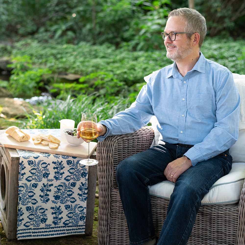 Model posing next to table runner.